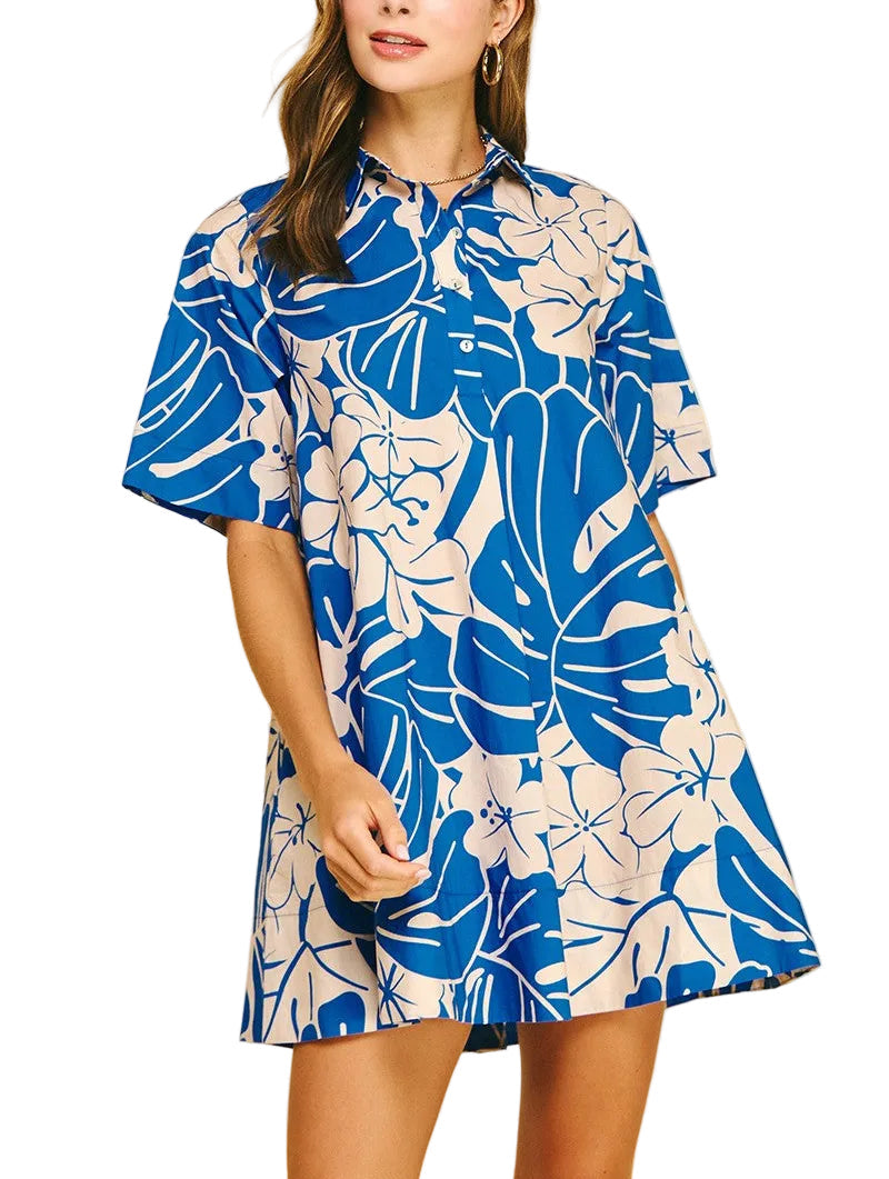 Woman wearing a blue and white floral dress on a beige background