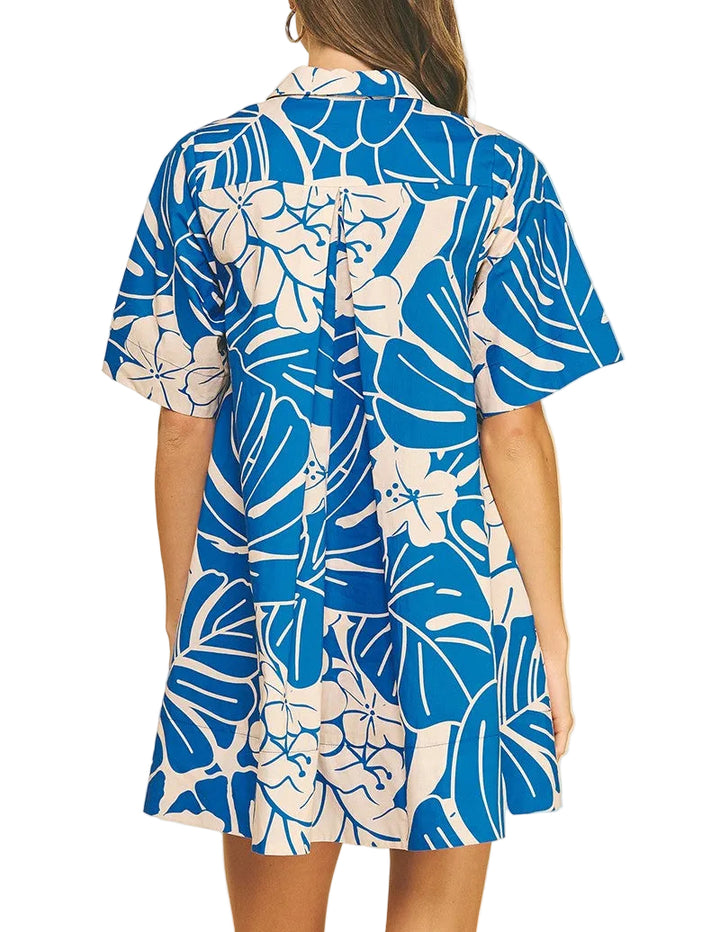 Woman wearing a blue and white floral dress on a beige background