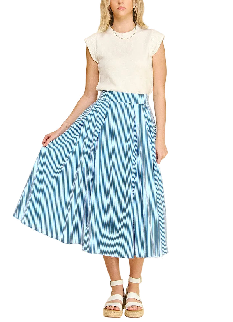 Woman wearing a white top and blue striped skirt on a beige background