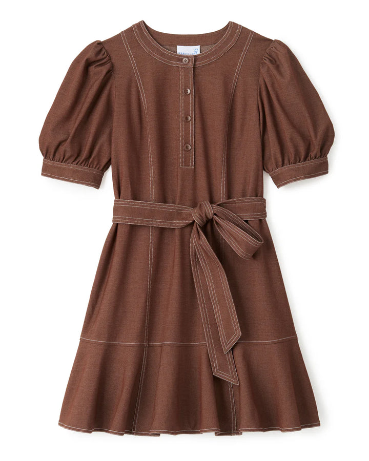 The Bonnie Mini Dress brings structure and charm to cooler days—cut in warm mocha twill, with sculpted sleeves and sweeping seams. Finished with contrast stitching and a flounced hem, it nods to vintage tailoring with a distinctly modern air.

Defined Shape: Puff sleeves and princess seams for subtle structure
Custom Fit: Detachable self belt for adjustable waist emphasis
Artful Contrast: Tonal topstitching and a full, circular-cut mini hem