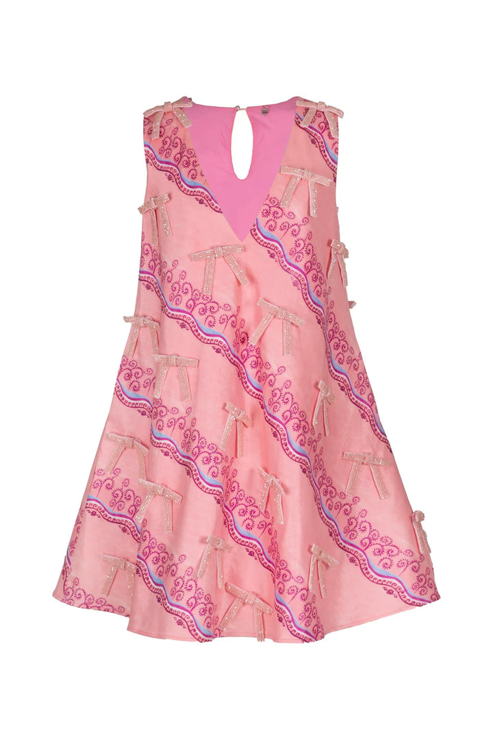 A cosmic dose of charm. The Cassiopeia Dress is a playful nod to femininity with its A-line silhouette, shimmering pink fabric, and delicate embroidered bows in a fun mix of blues and deep pinks scattered throughout. Its flattering V-neckline and wavy pattern detailing add a lighthearted yet refined touch — perfect for any evening event. Designed with practical side pockets, it blends charm with effortless functionality.

