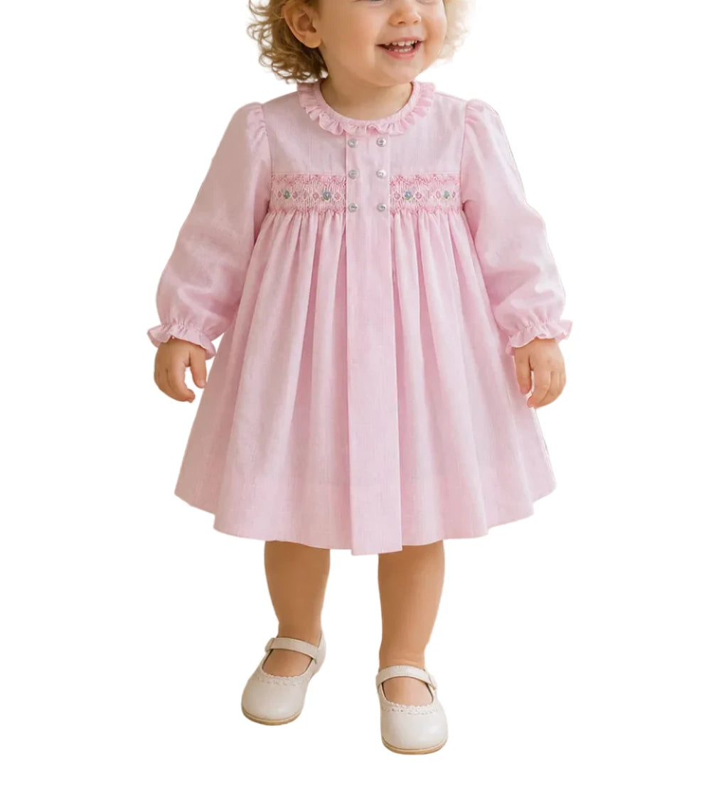 AN CLASSIC AND SIMPLE DRESS THAT IS PERFECT FOR FALL WITH CHARMING SMOCKING AND DELICATE EMBROIDERY, YOUR LITTLE ONE WILL BE COMFORTABLE WITH A TOUCH OF SWEETNESS!

This long sleeve dress comes in a pink check fabric that is perfect for fall and winter with a center box pleat with decorative buttons and a smocked panel with embroidered details.

The lightweight cotton blend fabric keeps little ones cool and comfortable and is easy to care for - just machine wash and tumble dry. 