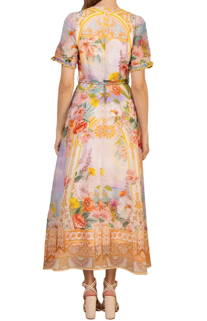 Woman wearing a floral dress against a white background.