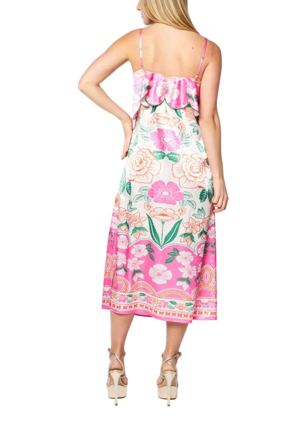 Woman wearing a floral dress with pink flowers on a white background