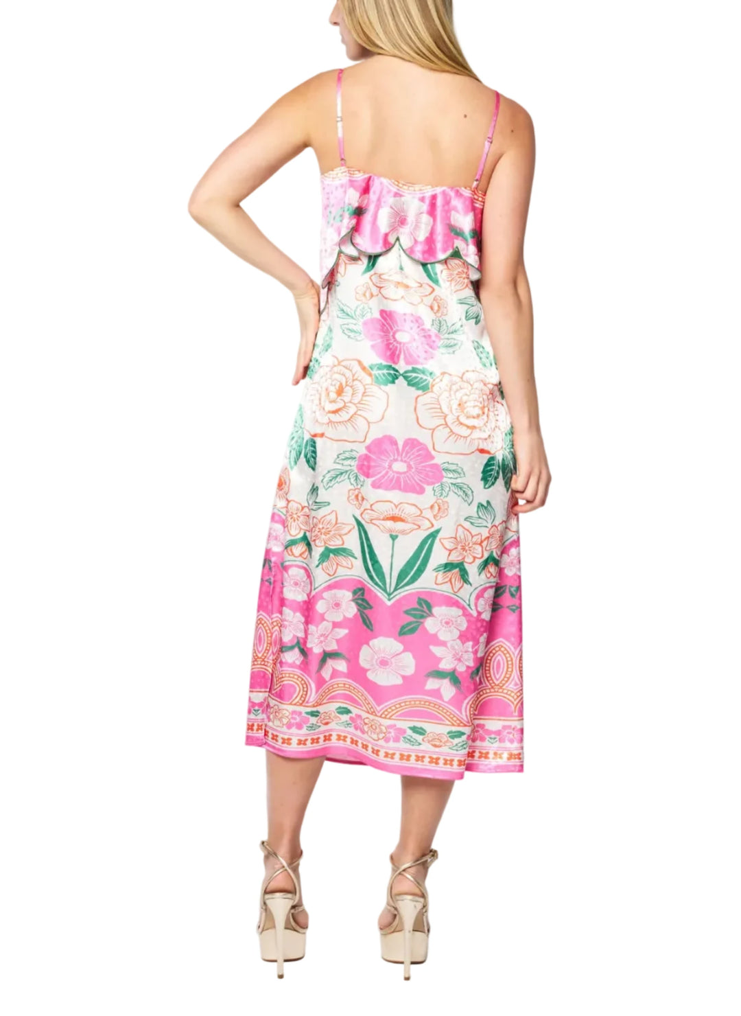 Woman wearing a floral dress with pink flowers on a white background
