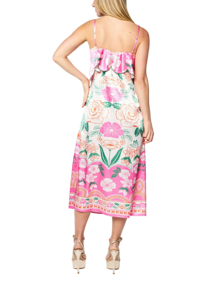 Woman wearing a floral dress with pink flowers on a white background