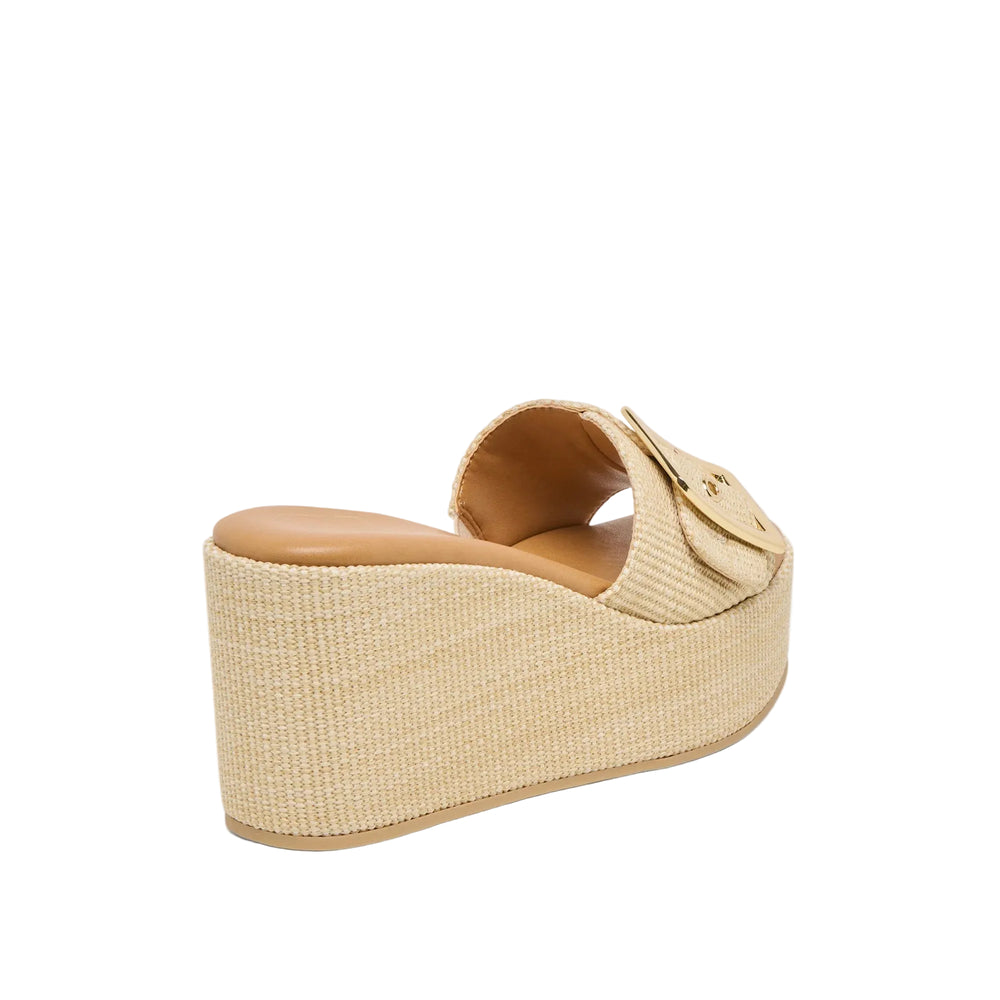 Step out in JILIAN’s head-turning details this season. This platform wedge features a slide-on silhouette with a belt-like strap and oversized maximalist metal buckle. Available in light natural or warm mocha raffia, her all-over raffia texture is a classic and versatile upgrade to any warm weather wardrobe. Her supportive wedge sole is comfortable for all-day wear while her elevated details dress up almost any outfit. 