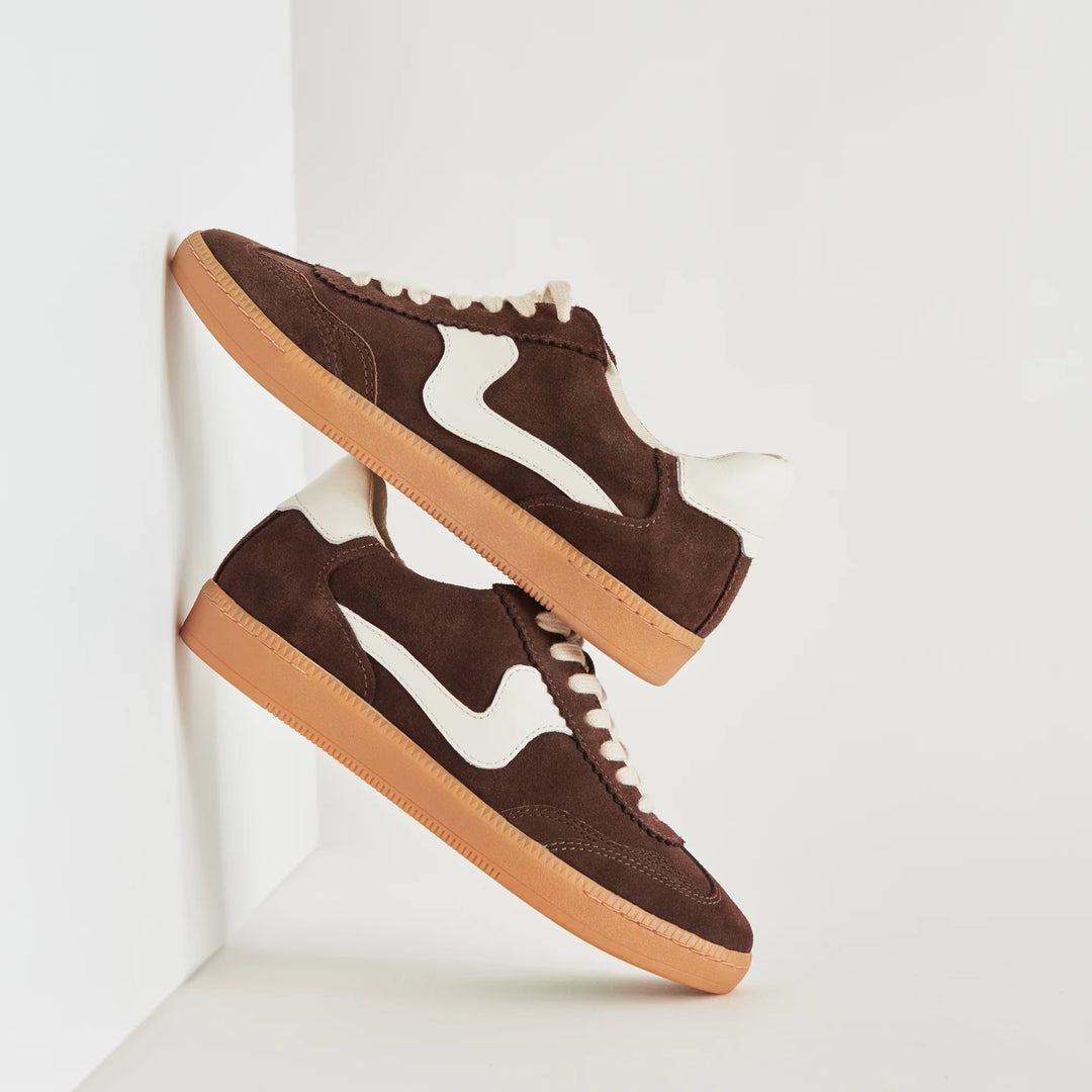 Product details
NOTICE is a real crowd pleaser. Her sporty, vintage vibe meets all new colorways in neutral and warm toned suede that are guaranteed to get noticed.

Suede Upper
Rubber Outsole
Recycled Textile Lining
Synthetic Sock
Removable Insole (1" Back Height, 0.3" Front Thickness)
Imported