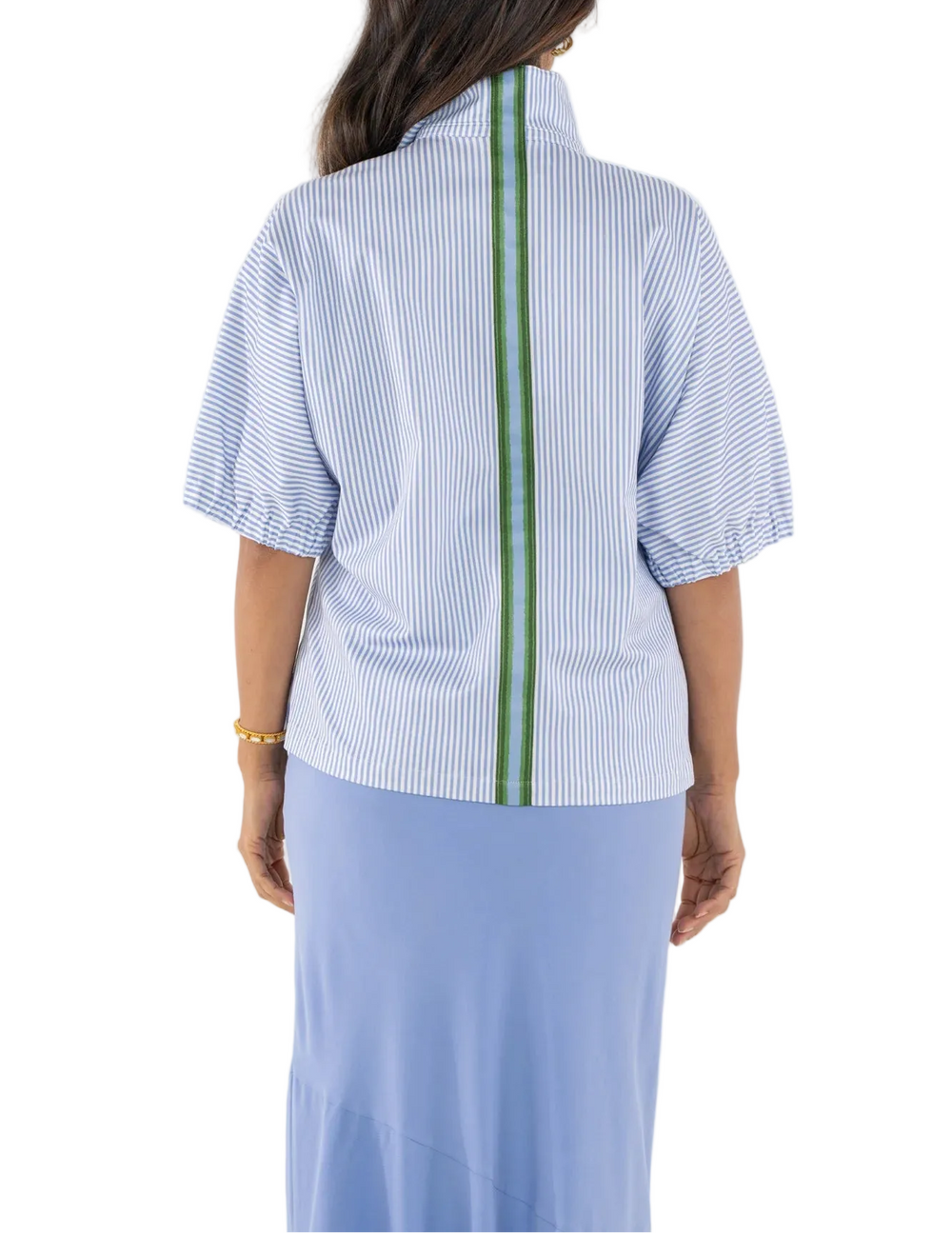 The Poppy Top in Grapemist Stripe is an effortless staple with a playful twist. Designed with a loose, easy silhouette, this style offers a relaxed feel while maintaining a polished look. Soft elastic dolman sleeves add gentle volume, balanced by a classic stand collar for a timeless finish. This top brings a fresh, spring-ready appeal, elevated by an unexpected pop of color along the back with green and blue trim. 