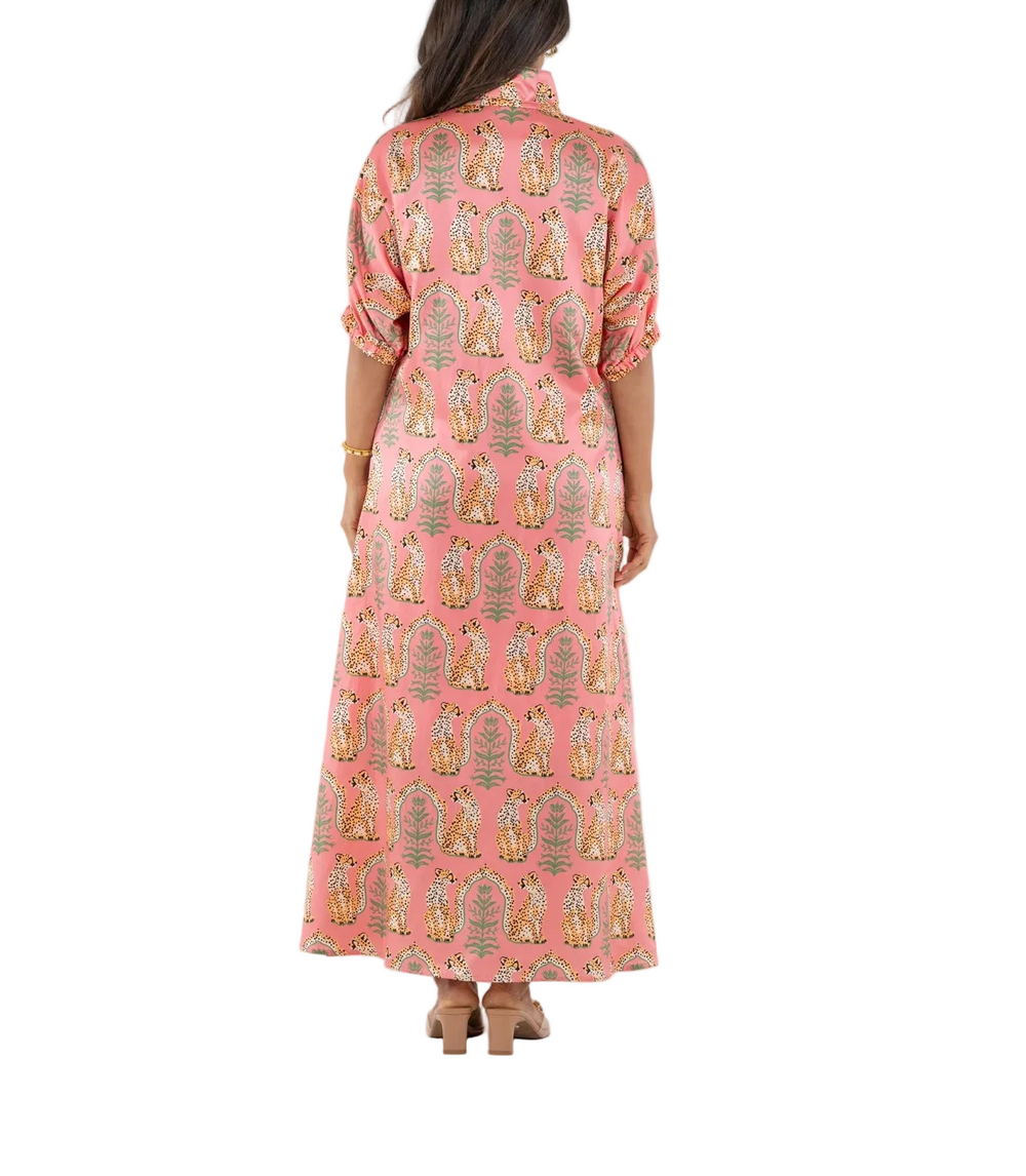 The Poppy Maxi in Cabana Cat is an understated statement with a playful edge. Designed with a classic stand collar, relaxed dolman sleeves with soft elastic, and a loose, flowing silhouette, it moves with ease and grace. The Cabana Cat print brings a sense of whimsical majesty, featuring regal cheetahs set within a symmetrical jungle of architectural motifs—perfect for elevated occasions that call for ease and impact.