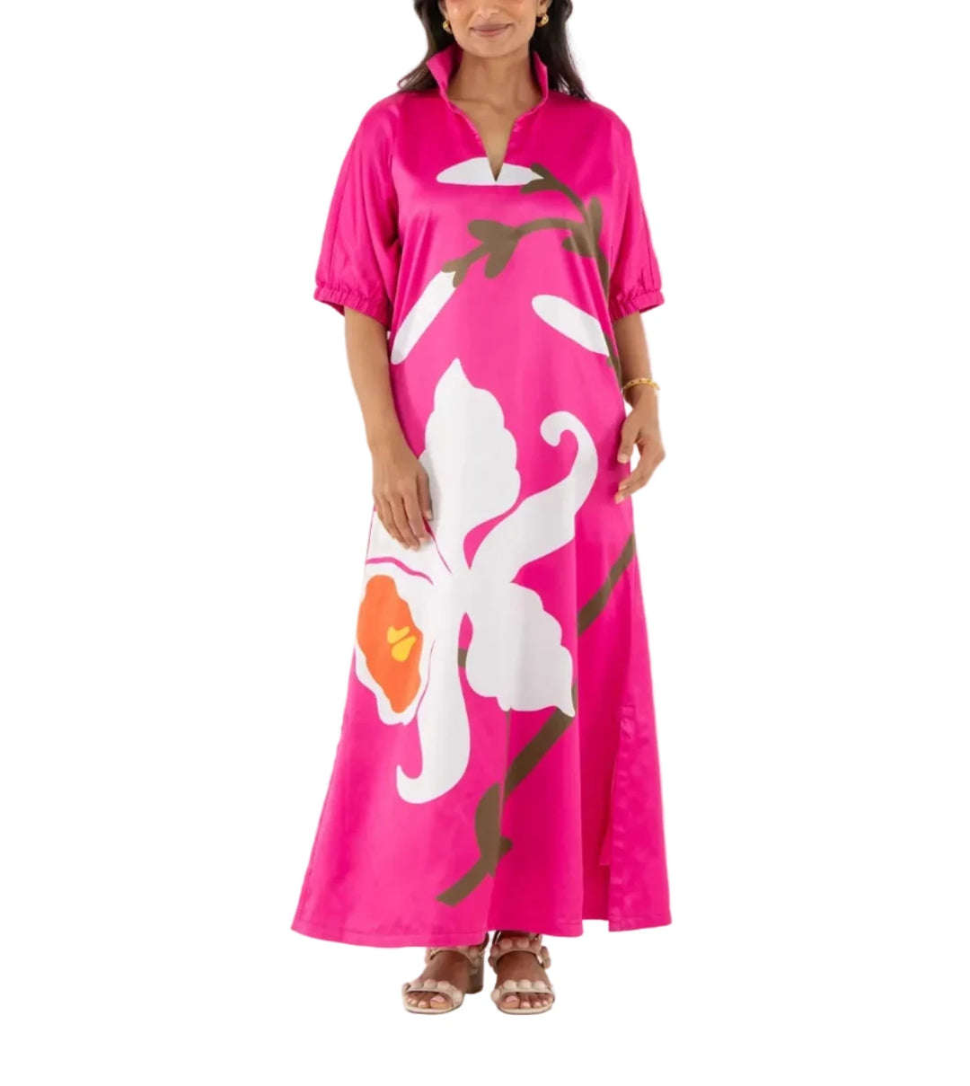 The Poppy Maxi in Holland Pink features a classic stand collar, loose dolman sleeves finished with elastic at the cuff, and a flowing, loose-fitting silhouette that moves with ease. The placed floral print makes a bold visual statement across the length of the dress, while maintaining a sense of softness and graceful energy throughout the design.