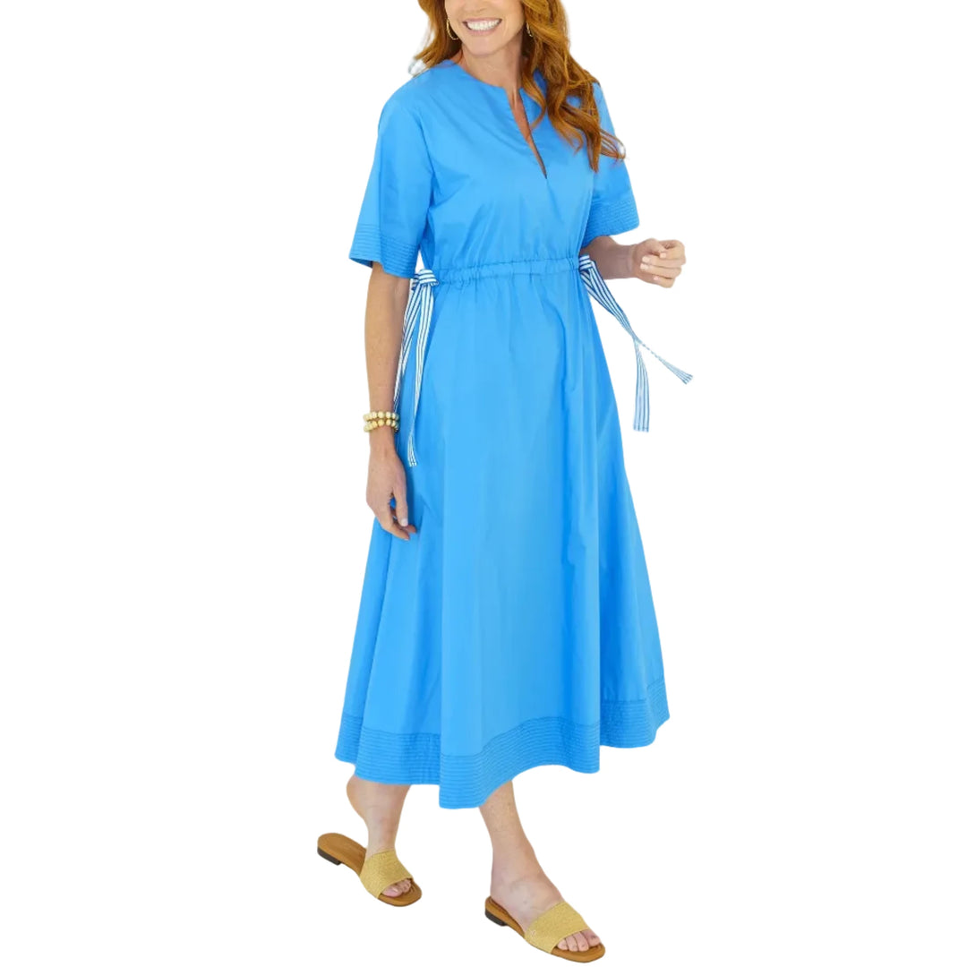 The Ali Dress is a fun new silhouette designed to bring playful detail to an easy, everyday look. Featuring a flattering V-neckline and short sleeves, this 50-inch style is adorned with grosgrain ribbon along the sides that creates a unique drawstring effect — allowing you to cinch the waist for a more defined shape or wear it relaxed and effortless. Crafted for comfort and style, this dress is finished with pockets for that extra touch we all love.

Flattering, functional, and full of personality, the Ali 