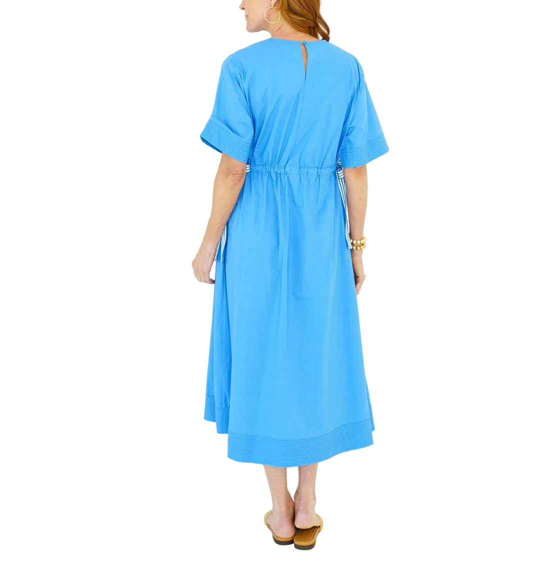 The Ali Dress is a fun new silhouette designed to bring playful detail to an easy, everyday look. Featuring a flattering V-neckline and short sleeves, this 50-inch style is adorned with grosgrain ribbon along the sides that creates a unique drawstring effect — allowing you to cinch the waist for a more defined shape or wear it relaxed and effortless. Crafted for comfort and style, this dress is finished with pockets for that extra touch we all love.

Flattering, functional, and full of personality, the Ali 