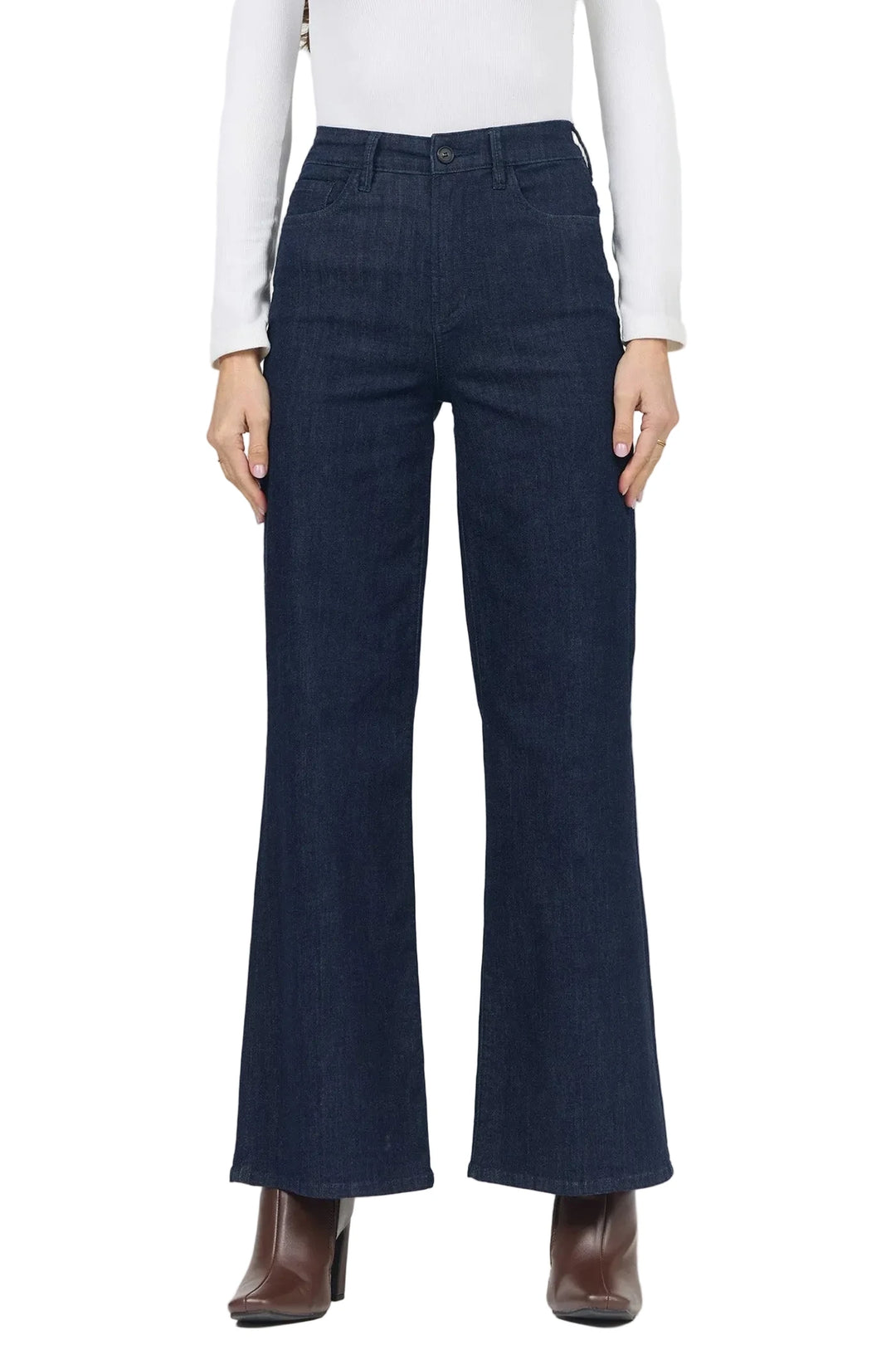 A model wearing dark blue wide-leg flare jeans, paired with a white long-sleeve top and brown ankle boots, shown from the waist down against a plain white background.