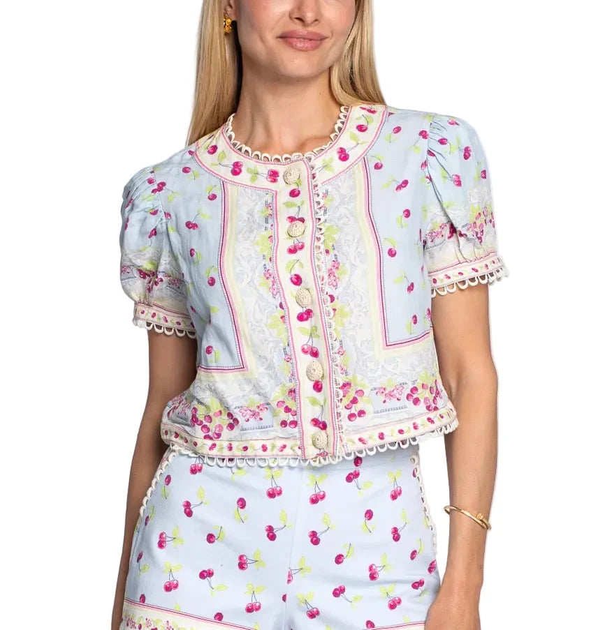 Woman wearing a matching top and shorts set with floral pattern on a white background
