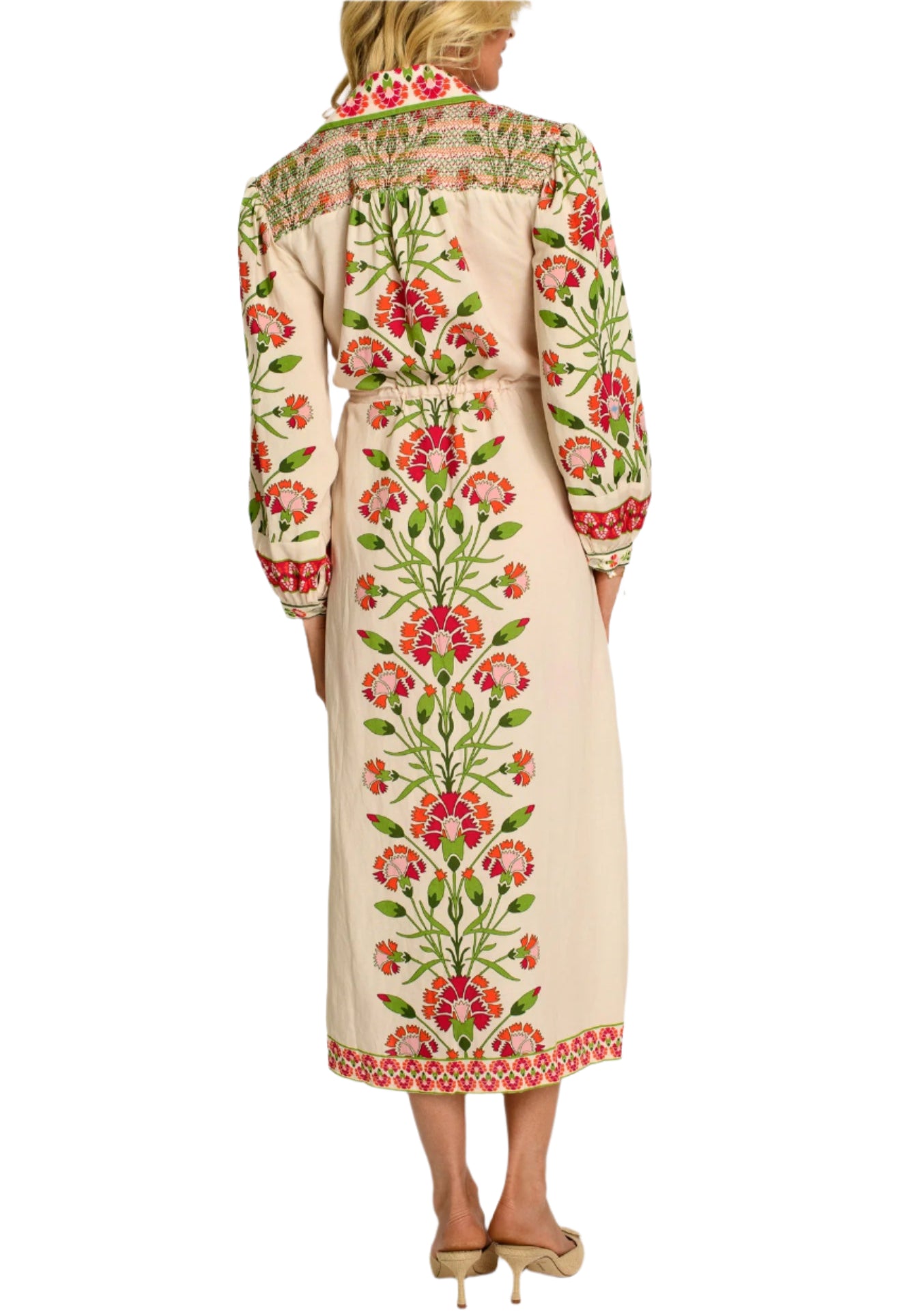 Lucia is intricately crafted from head to toe, featuring a collared neckline, colorful shoulder smocking, and side slits, all trimmed with a decorative border. Her drawstring waist makes her a comfortable, easy-wear style that can be dressed up or down.