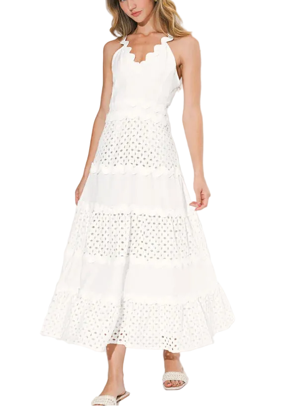 The Emma is defined by its mixed media construction, featuring a sophisticated, form-fitting bodice that seamlessly transitions into a voluminous, tiered maxi skirt. The bodice is detailed with a clean V-neckline and delicate adjustable spaghetti straps, while the skirt offers a rhythmic, ruffled texture that adds a sense of airy movement to every step.