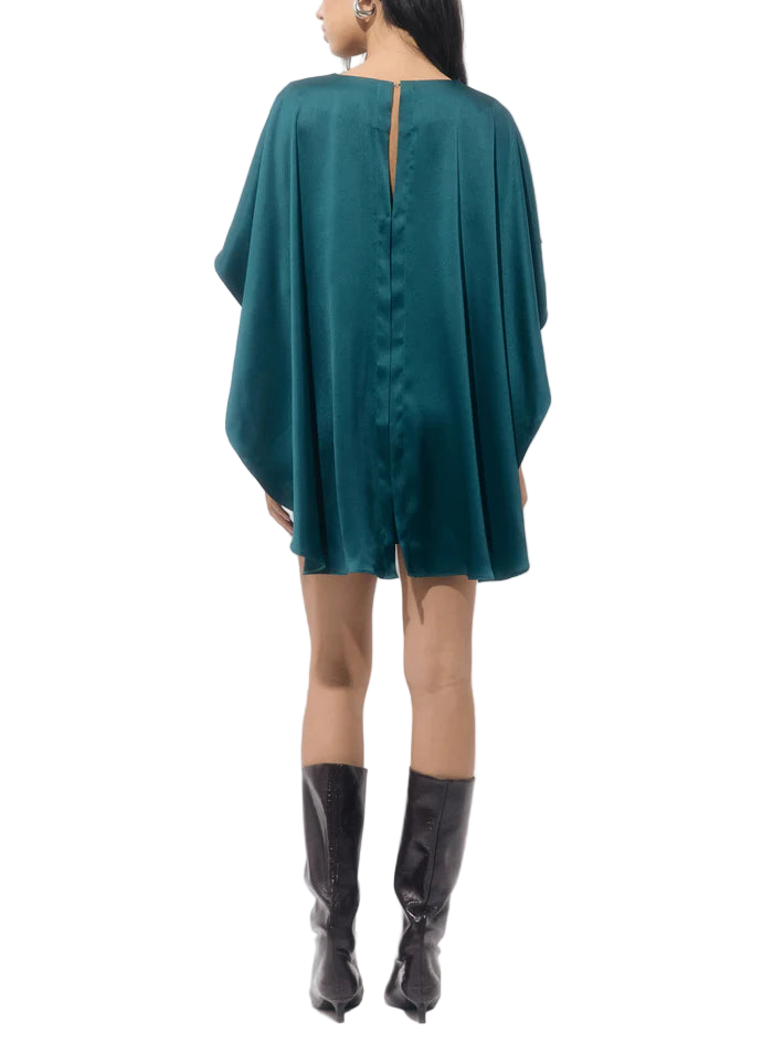 The classic sheath silhouette is updated with a sophisticated attached cape overlay that drapes gracefully over the shoulders and upper arms, creating a stunning, fluid effect. It features a simple round neckline and a tailored midi-length skirt, which is cut with a slit (visible in the images) to allow for movement.