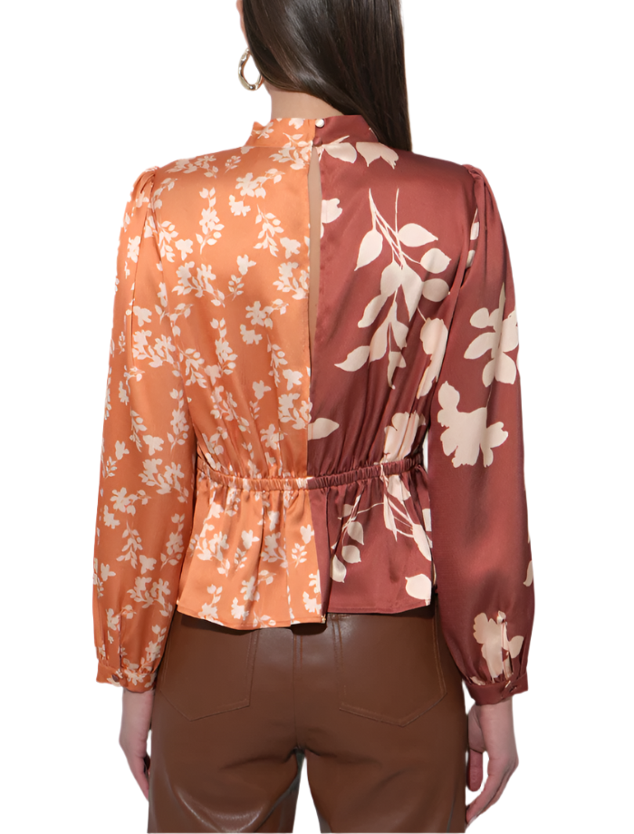 Brighten your wardrobe with the Ruiza Two Tone Mock Neck Blouse in Marigold and Brown. This playful blouse pairs a cheerful marigold hue with warm brown accents, creating a fun and stylish contrast.