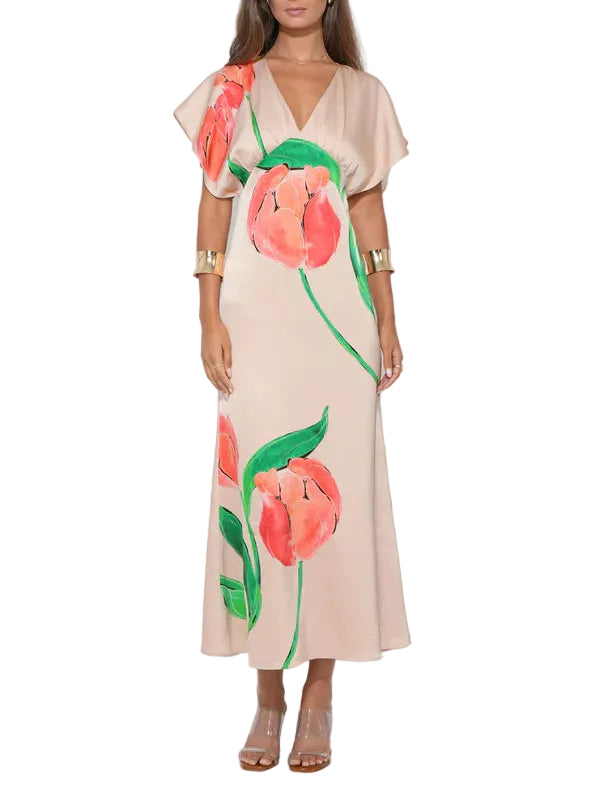 The silhouette is defined by its whimsical flutter sleeves, which provide soft movement and a feminine frame for the upper body. The midi length offers a sophisticated, grounded balance to the playful sleeves and vibrant pattern, making it a versatile piece for various dress codes.

