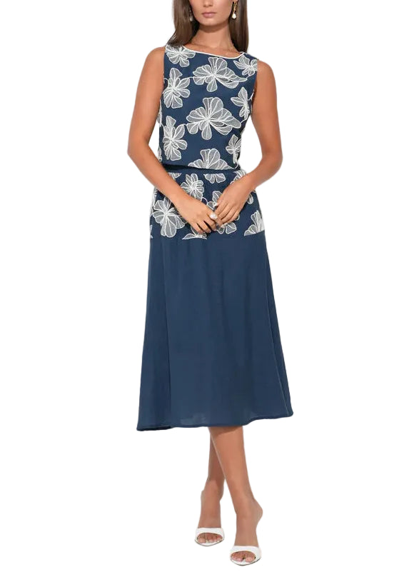 Designed in a classic Navy and Cream color palette, the Alani skirt is defined by its tiered construction, which adds a beautiful sense of movement and "swish" to your step. The deep navy fabric serves as a rich canvas for intricate cream embroidery, likely flowing across each tier in a delicate or geometric motif.
