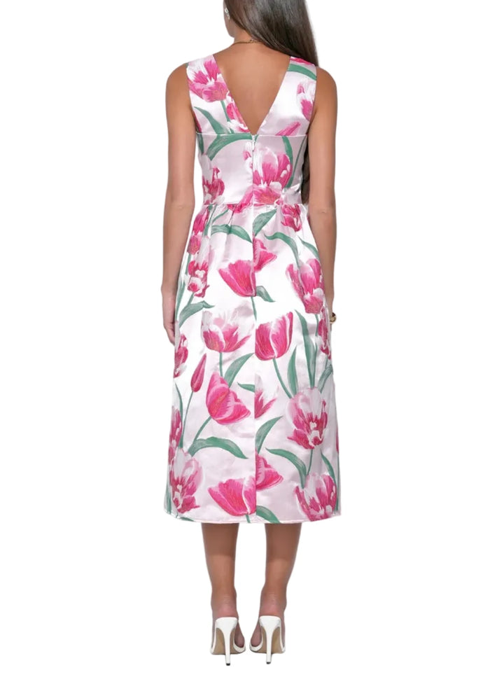 The jacquard weave creates a raised, dimensional floral pattern that catches the light with every movement, giving the dress a sophisticated, high-end weight. The sweetheart neckline offers a romantic, contoured frame for the décolletage, while the midi-length skirt provides a graceful, tea-length sweep that is both modest and chic.
