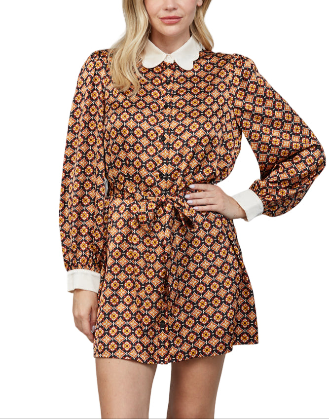 Step out in style with the Marcie Dress in Black Multi, featuring a charming scallop collar that adds a flirty touch to your look. This mini dress combines playful design with effortless elegance.