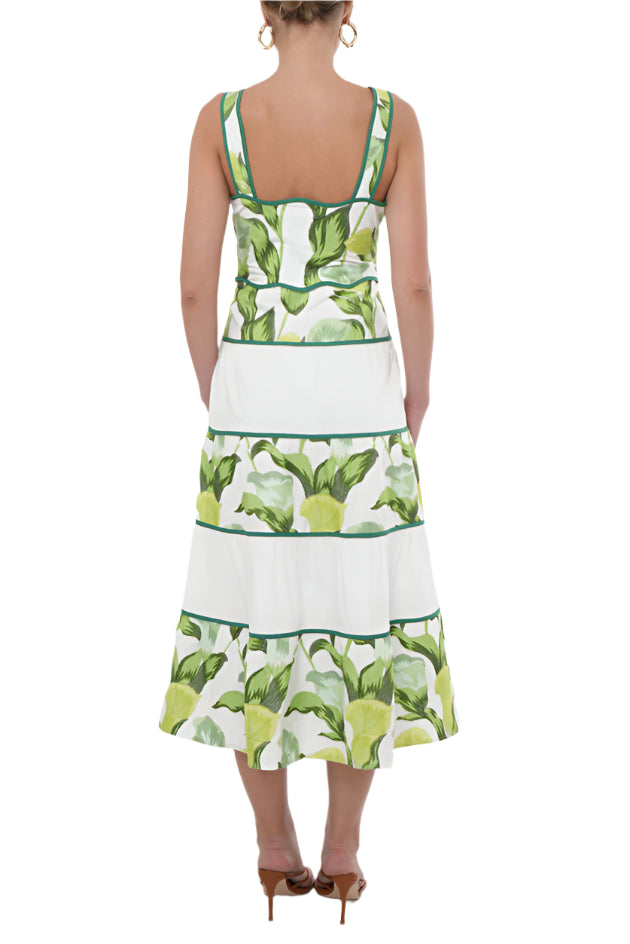 Crafted for elegance, the "Lisha Dress" features a stunning green floral pattern that is perfectly complemented by the contrasting white tiers on the skirt. The scallop neckline and waistline add a touch unique, finishing touch.