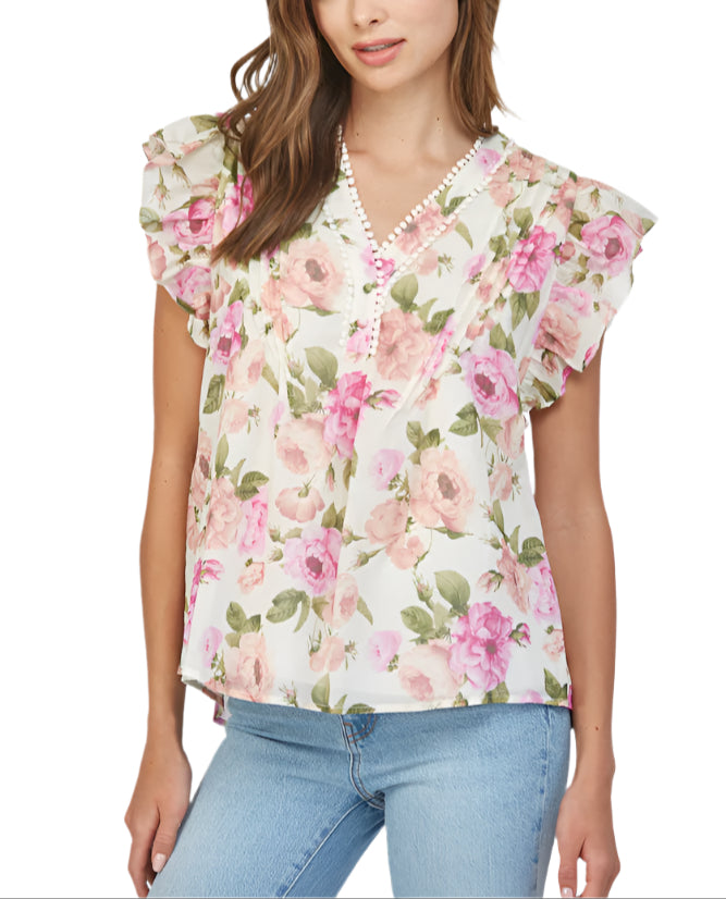 Introducing the Margaret Ivory Multi Top, the perfect addition to your wardrobe! With tuck detailing on the front and flutter sleeves, this top adds a touch of elegance to any outfit.&nbsp;