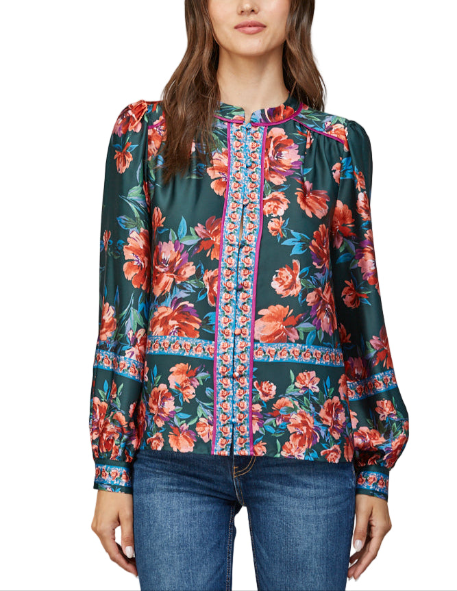 Add a splash of charm to your wardrobe with the Jaci Blouse in Deep Green Multi. Its long sleeves offer the perfect balance of cozy and stylish, while the rich green hues and playful pattern make it a standout piece for any occasion.