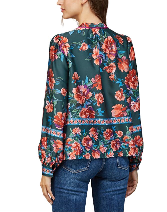Add a splash of charm to your wardrobe with the Jaci Blouse in Deep Green Multi. Its long sleeves offer the perfect balance of cozy and stylish, while the rich green hues and playful pattern make it a standout piece for any occasion.