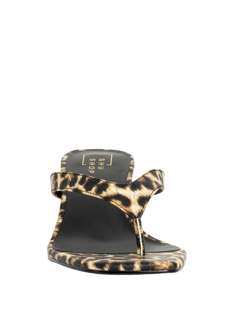 Leopard print sandal with black sole on a white background