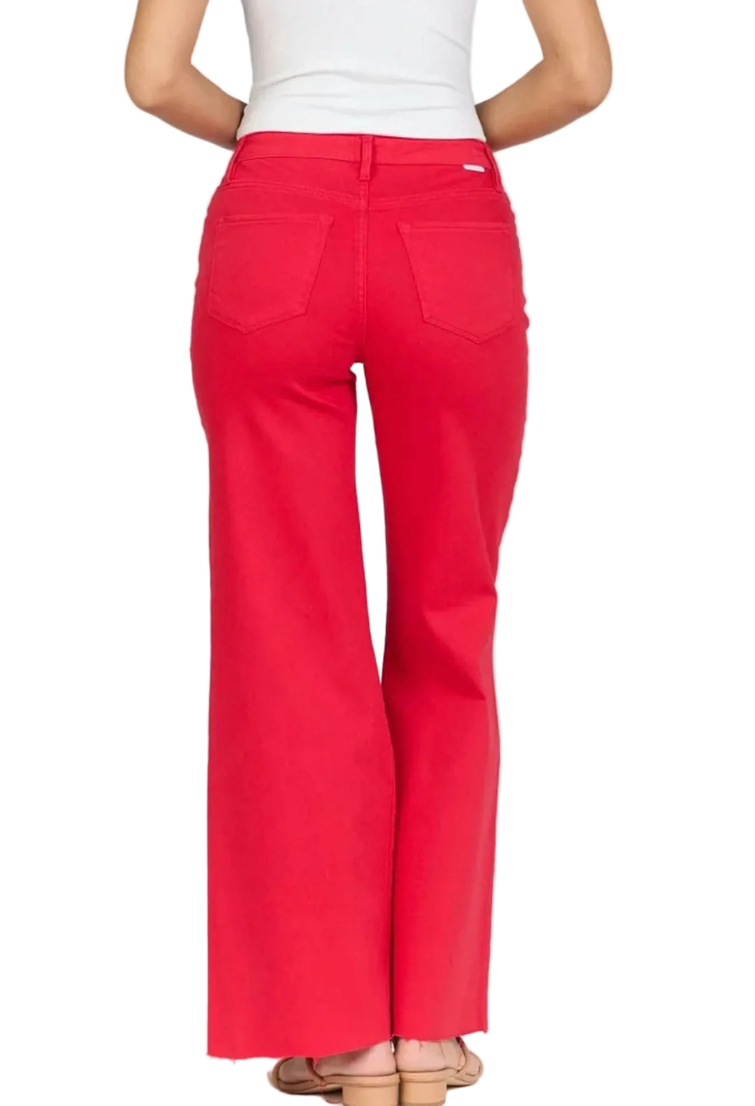 Red pants worn by a person on a white background