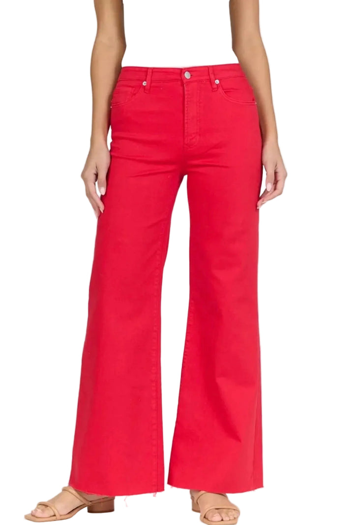 Red flared jeans worn by a person on a white background