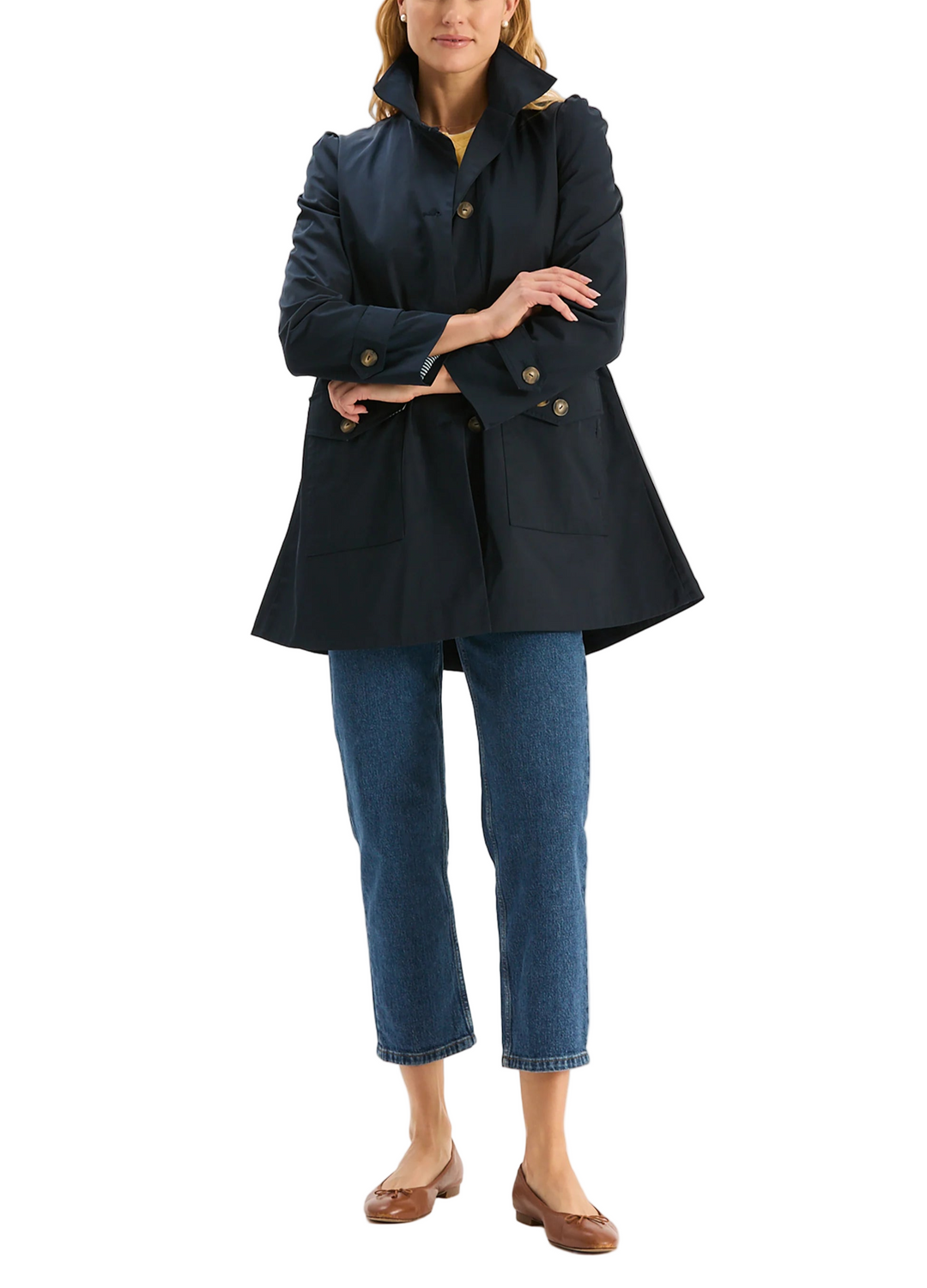 Crafted from a durable, weather-ready fabric, the Sutton Water Repellent Trench is designed to keep you dry without sacrificing style. The silhouette features a high stand collar, button-front closure, and tailored seams for a flattering, structured fit. With roomy flap pockets, this coat is both practical and polished.

Front button closure with tortoise shell-style buttons
Stand collar
Two front flap pockets with button closures
Adjustable button-tab cuffs
Slightly gathered puff shoulders
