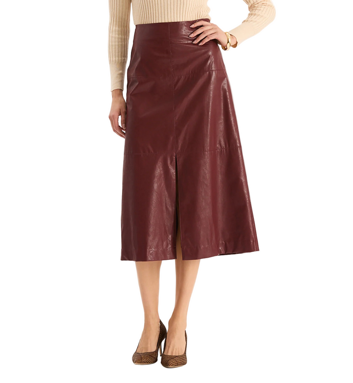 The Pheobe Vegan Leather Skirt has a luxurious feel with modern edge. This midi features a sleek, A-line silhouette with front slit detail that adds movement. Perfect with slim turtlenecks, silk blouses, or tailored jackets, it’s a versatile style that transitions seamlessly from day to night.

High-waisted silhouette
Front slit at bottom hem
Back zip closure
A-line silhouette
Shell: 100% Viscose, Coating: 100% Polyurethane
Lining: 100% Polyester
Turn inside out and machine was cold, hang dry