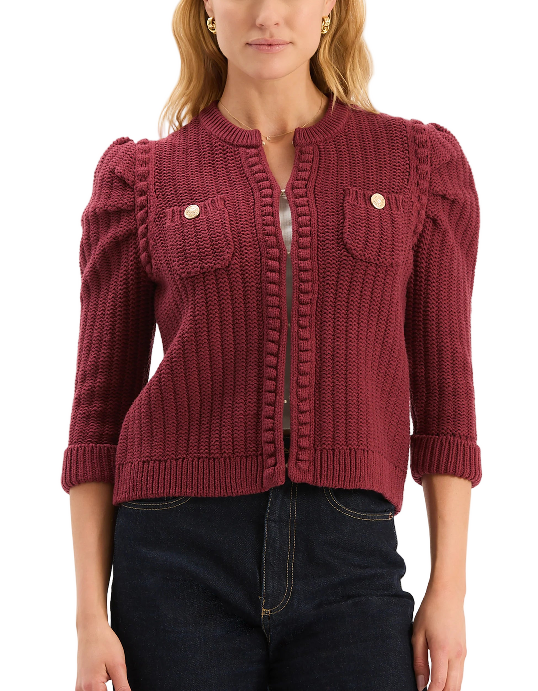 This cardigan can be worn like a little couture jacket that's revisited in knit. The cardigan has a slightly cropped shape, a round neckline and statement puffed shoulders. Elevated with gold buttons, this piece is easy to wear mid-season and layered as the weather gets colder.

Slightly puffed, three-quarter length sleeves
Front patch pockets
Front hook-and-eye closure
Gold button detail
59% Cotton, 38% Acrylic, 2% Nylon, 1% Spandex
Hand wash cold or dry clean