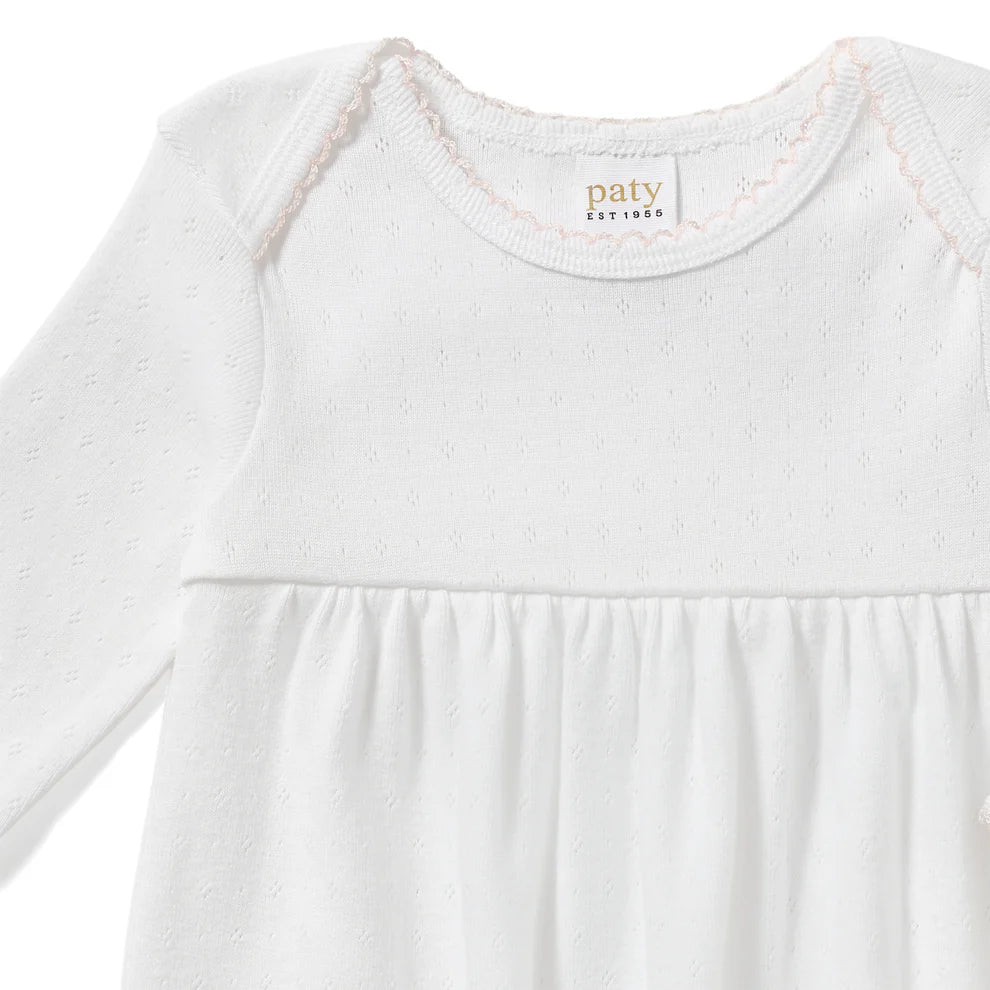 Designed with a softly gathered silhouette and finished with delicate picot trim at the neckline and cuffs, this gown blends comfort with classic detail. The elasticized hem makes diaper changes quick and convenient while keeping baby cozy.