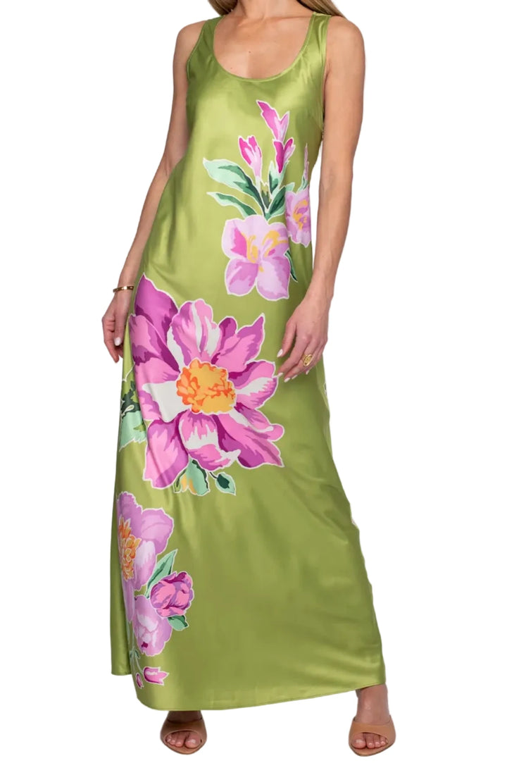 Woman wearing a green dress with pink floral patterns on a white background
