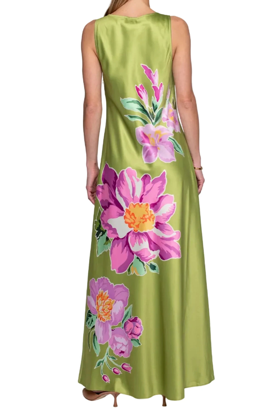 Woman wearing a green dress with floral patterns on a white background