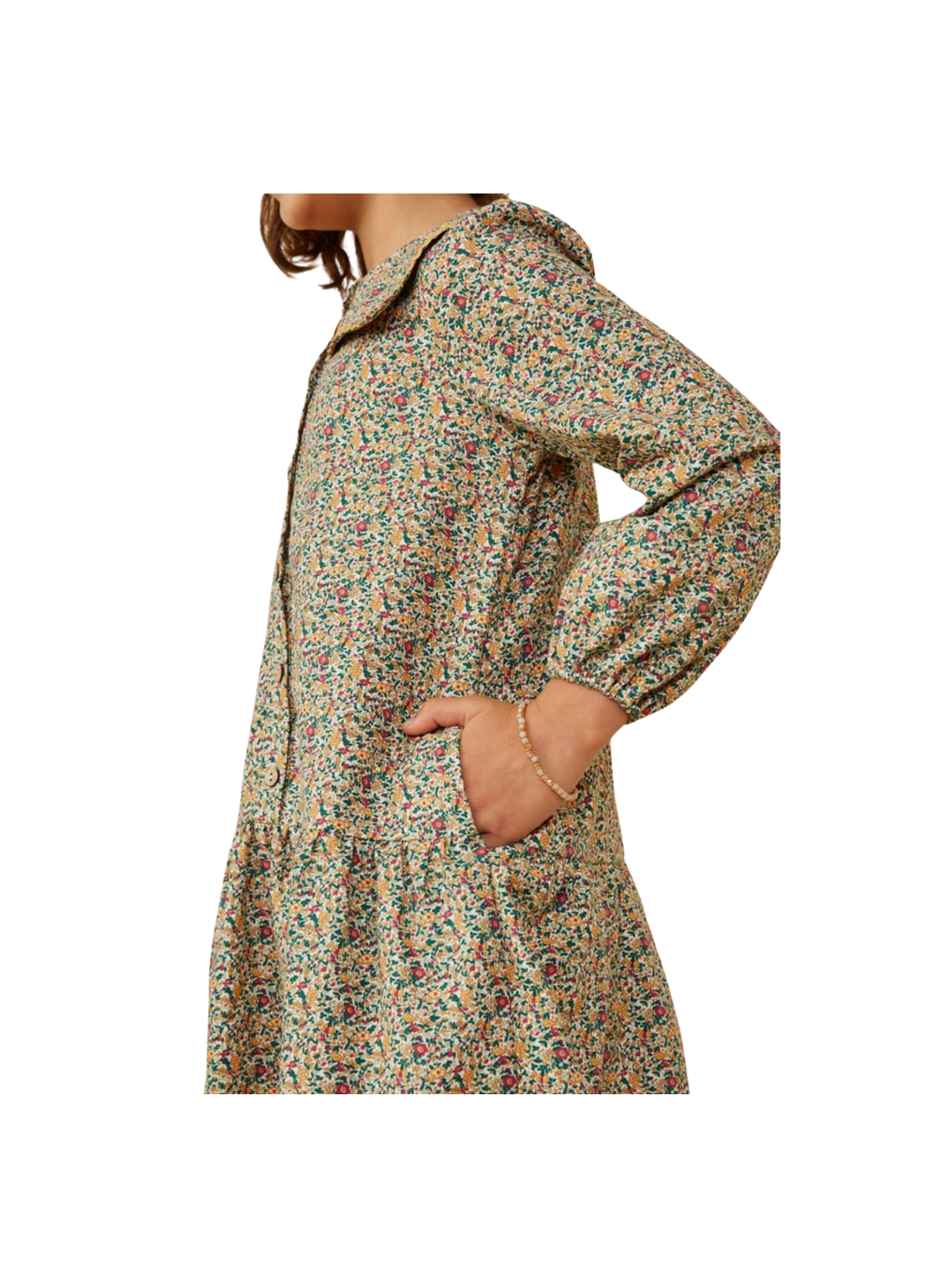 A person wearing a long-sleeve hooded raincoat with a dense multicolor floral print on a light beige base, shown from the side against a plain white background.
