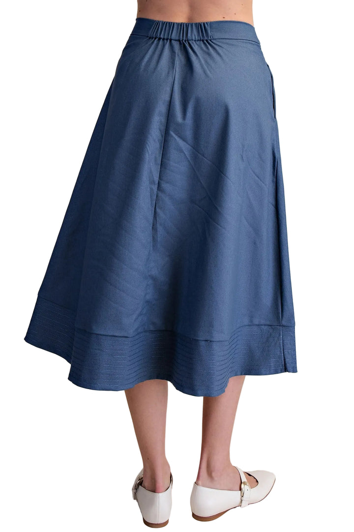 The Gloria A-Line Midi Skirt in Indigo combines timeless elegance with everyday wearability. This flattering silhouette skims the body with a graceful A-line cut that elongates your frame, while the midi length offers versatile styling for any occasion. Crafted with precision, the stitch hem detail adds a refined finish that keeps its shape through countless wears. The rich indigo hue pairs effortlessly with neutral tops or bold prints, making it a wardrobe essential that transitions seamlessly from office 