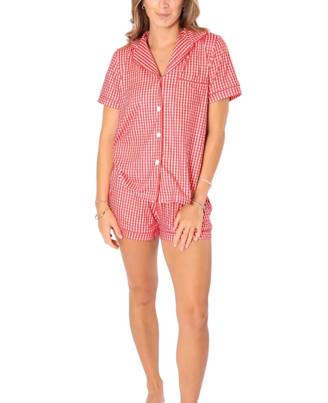 Woman wearing a red checkered outfit against a white background