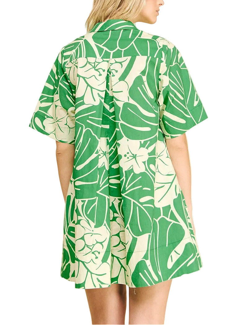 Woman wearing a green and white leaf-patterned dress on a beige background