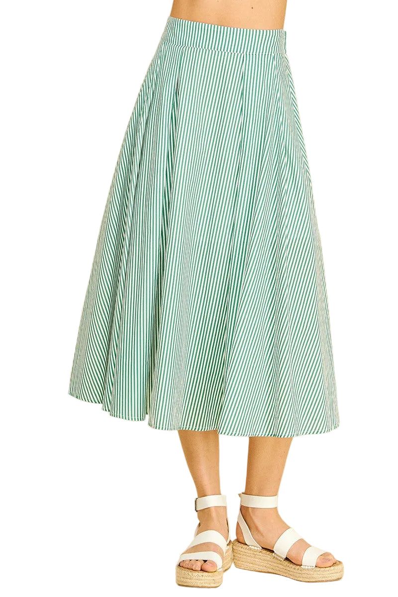 Person wearing a green and white striped skirt on a beige background