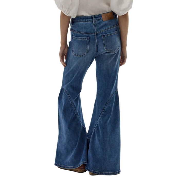A modern take on boho flair, the Gypsy Denim Pants feature a flattering high-waisted fit with a wide flared leg for a true gypsy silhouette. Crafted in a super-soft washed denim blend with a touch of spandex for comfort, they include classic back pockets and a clean waistband. Free-spirited style with a vintage soul.