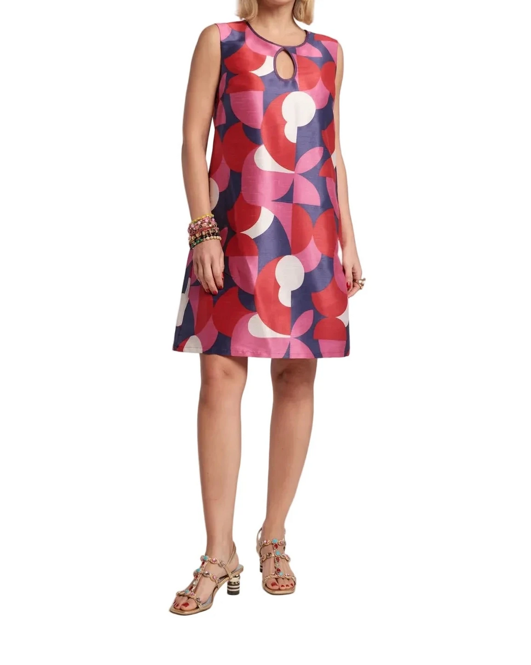 Woman wearing a colorful patterned dress on a white background