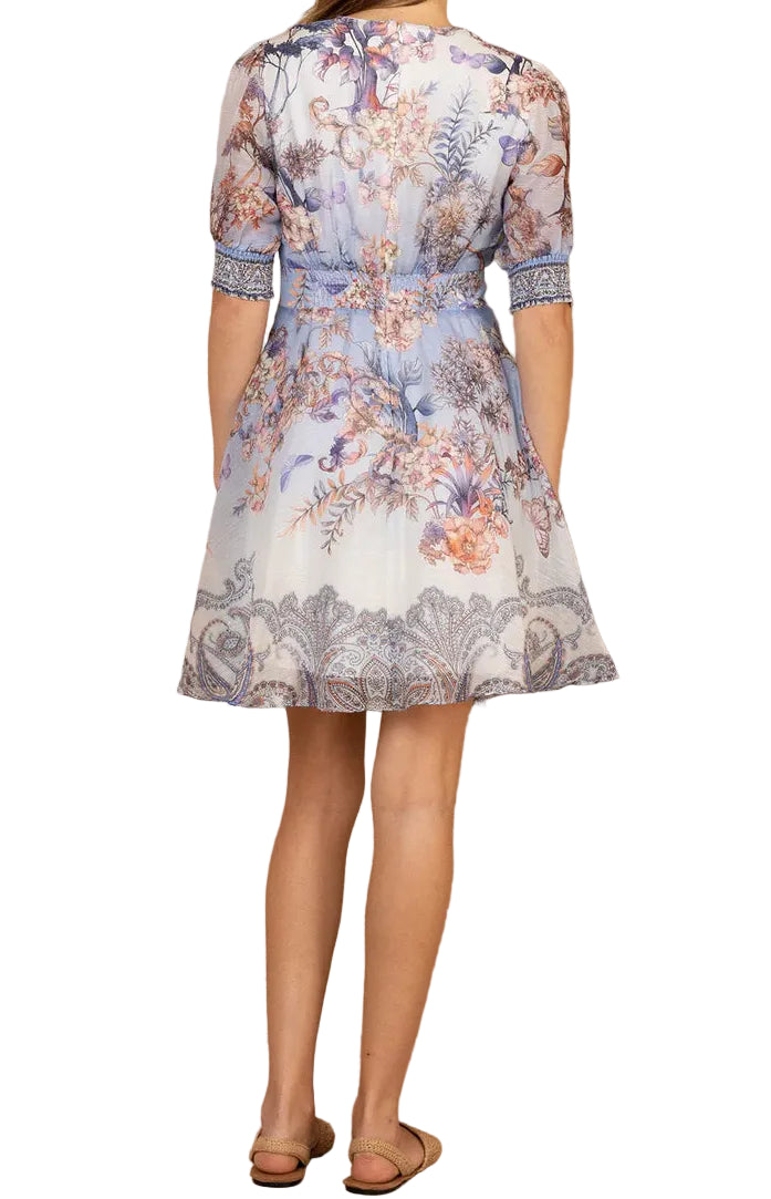 Floral patterned dress worn by a person on a white background