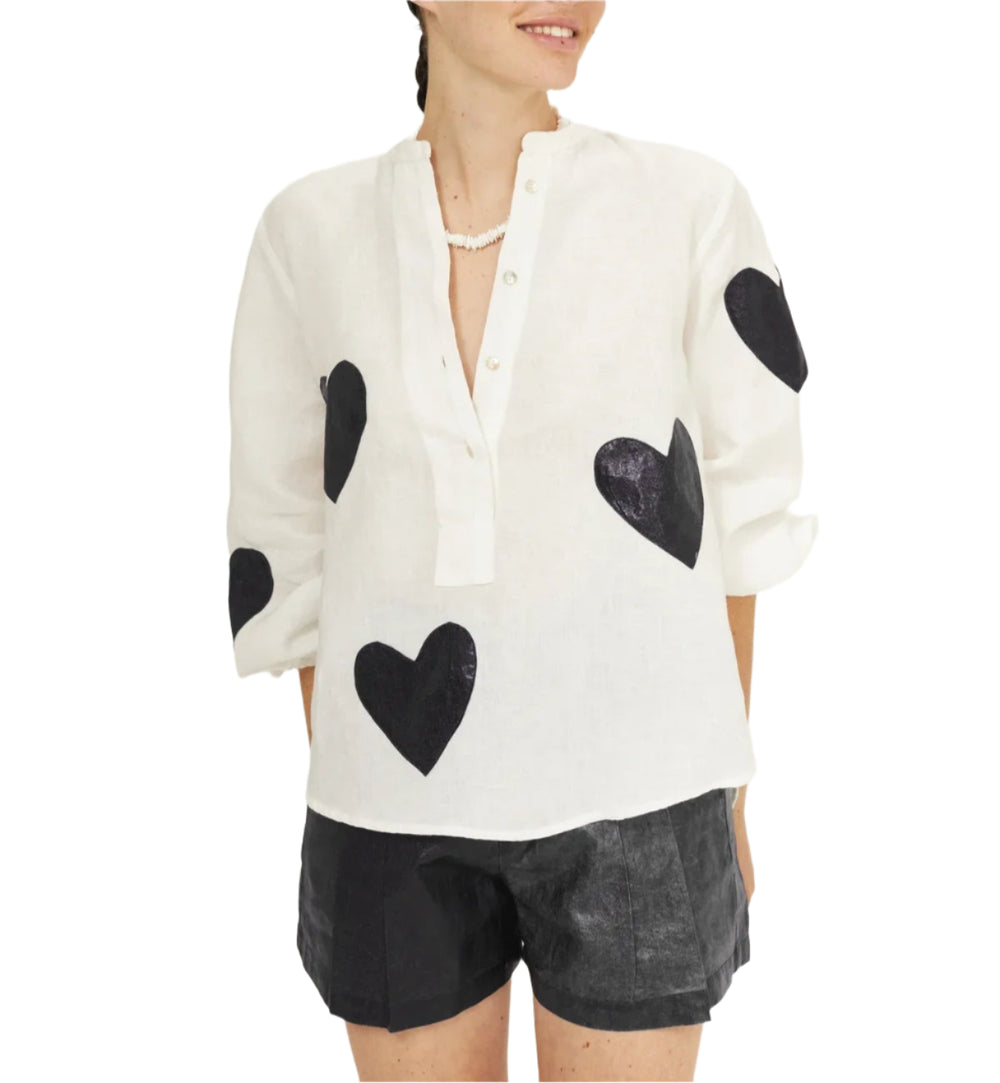 To fall in love with! The&nbsp;oversized Cupid Shirt&nbsp;is super comfy and elegant, featuring a mandarin collar, a hidden button placket, and puffed long sleeves.&nbsp;

Crafted with&nbsp;100% linen fabric,&nbsp;it has heart-shaped foil pink appliques that add a feminine and super fun vibe to this style.