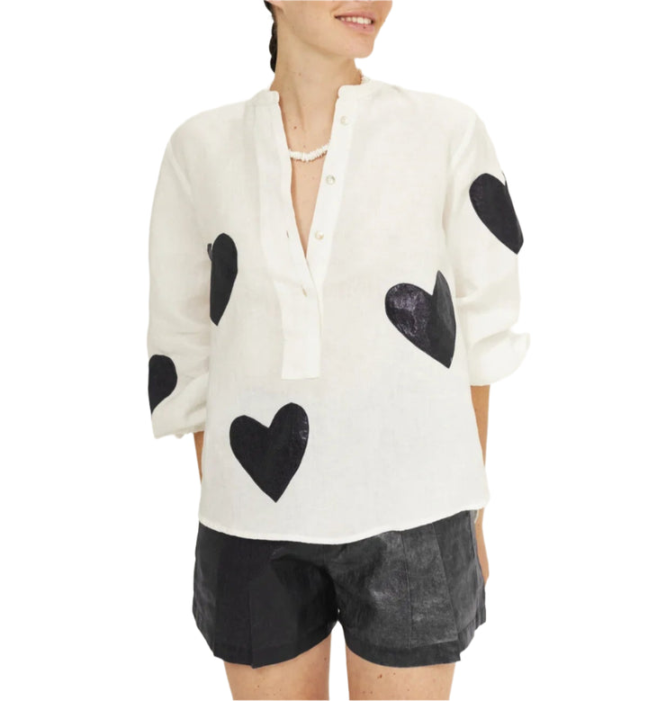 To fall in love with! The&nbsp;oversized Cupid Shirt&nbsp;is super comfy and elegant, featuring a mandarin collar, a hidden button placket, and puffed long sleeves.&nbsp;

Crafted with&nbsp;100% linen fabric,&nbsp;it has heart-shaped foil pink appliques that add a feminine and super fun vibe to this style.